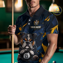 Load image into Gallery viewer, A front view of a custom blue billiards polo shirt worn by a male model holding a pool cue. The shirt features a funny cartoon bulldog with its paw on an 8-ball on the front. A 'YOUR NAME' text placeholder is positioned below a crossed pool cues icon. The background is a blurred billiards room with a green pool table.