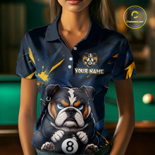 Load image into Gallery viewer, A front view of a custom blue and yellow billiards polo shirt worn by a female model . The shirt features  a cartoon bulldog with its paw on an 8-ball on the front. A 'YOUR NAME' text placeholder . The background is a blurred billiards room with a green pool table.