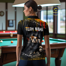 Load image into Gallery viewer, A back view of a custom black hip hop bulldog billiards polo shirt worn by a female model. The shirt features a bulldog on the back, with a large white 'TEAM NAME' text placeholder. The background is a billiards room with a table and hanging lights.
