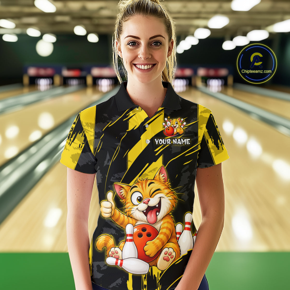 Female model wearing a custom black yellow cat bowling polo shirt front view featuring a playful cartoon cat, bowling ball, bowling pins and yellow black paint stroke pattern at the bowling alley