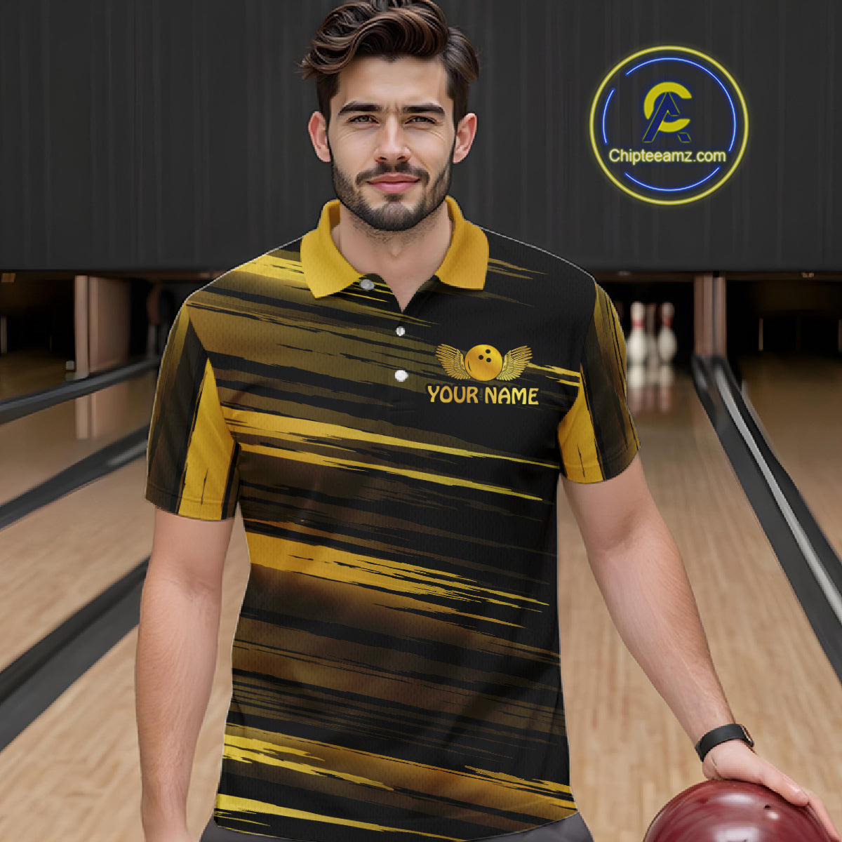 Male model wearing a custom black gold bowling polo shirt front view featuring a gold bowling ball emblem, dynamic gold brush stroke pattern and striped design at the bowling alley