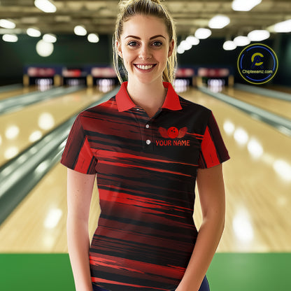 Female model wearing a custom black red bowling polo shirt front view featuring a red bowling ball emblem, dynamic red brush stroke pattern and striped design at the bowling alley