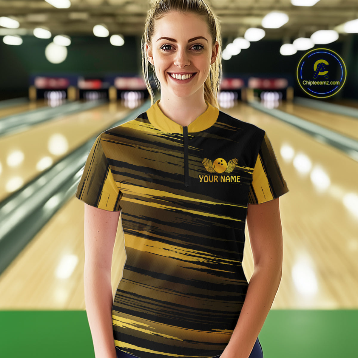 Female model wearing a custom black gold bowling quarter-zip shirt front view featuring a gold bowling ball emblem, dynamic gold brush stroke pattern and striped design at the bowling alley