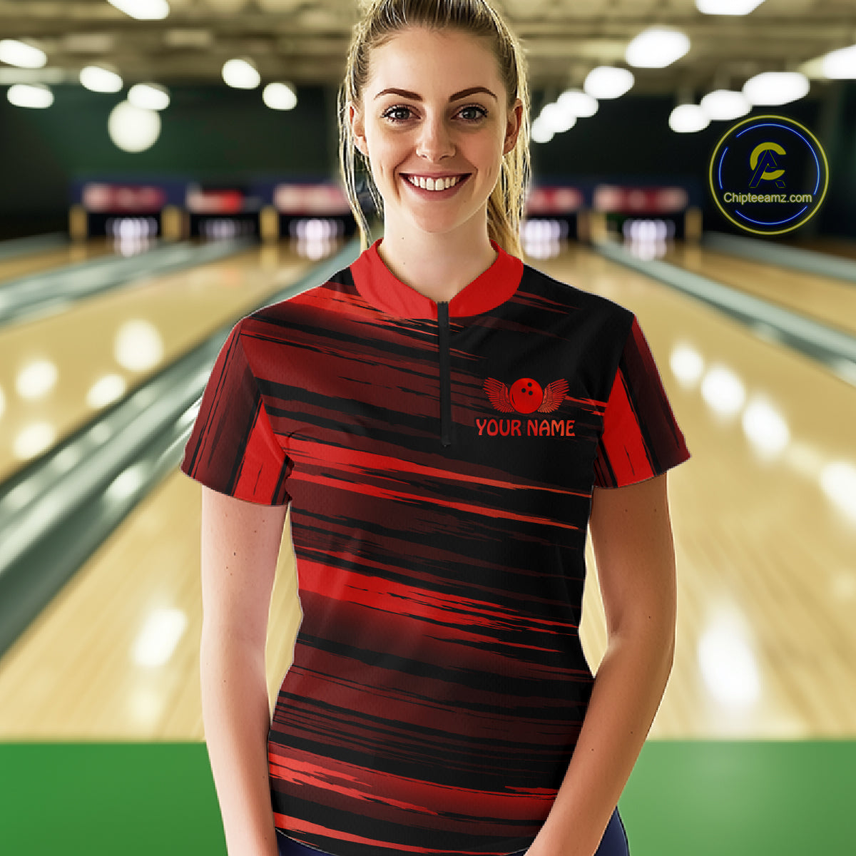 Female model wearing a custom black red bowling quarter-zip shirt front view featuring a red bowling ball emblem, dynamic red brush stroke pattern and striped design at the bowling alley