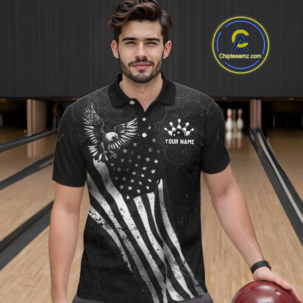 Male model wearing a custom black patriotic bowling polo shirt front view featuring a distressed American flag, bald eagle emblem and grunge pattern at the bowling alley
