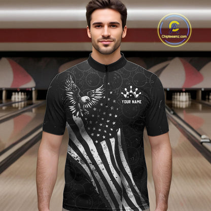Male model wearing a custom black patriotic bowling quarter-zip shirt front view featuring a distressed American flag, bald eagle emblem and grunge pattern at the bowling alley