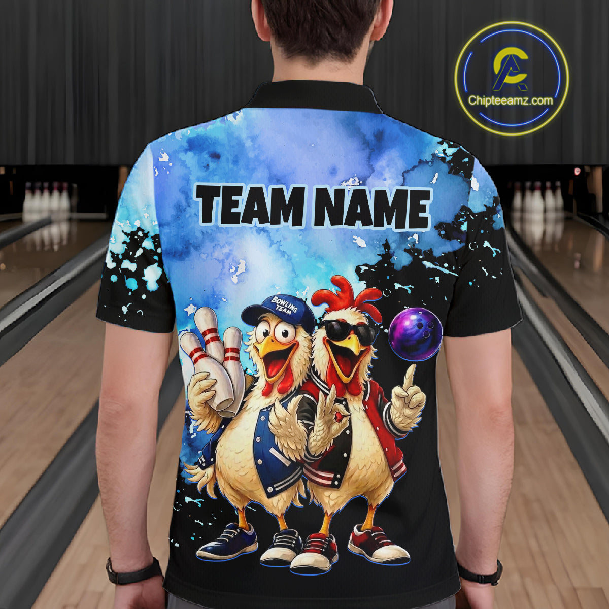 Person wearing a colorful shirt with cartoon chickens and 'TEAM NAME' text in a bowling alley.