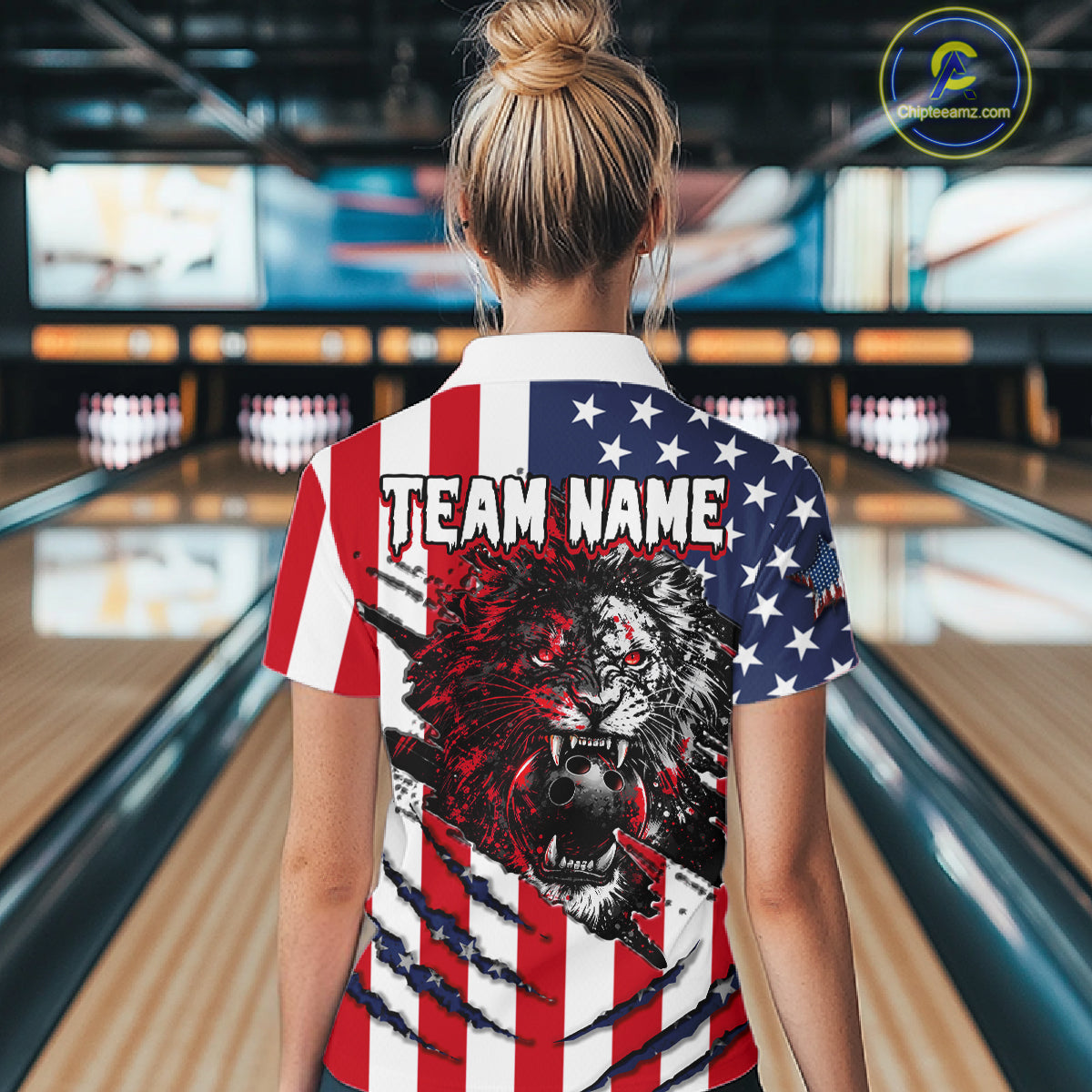 Person wearing a shirt with an American flag design and a lion graphic in a bowling alley.