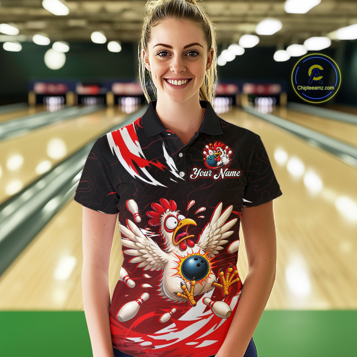Woman wearing a black bowling shirt with a colorful chicken design in a bowling alley.