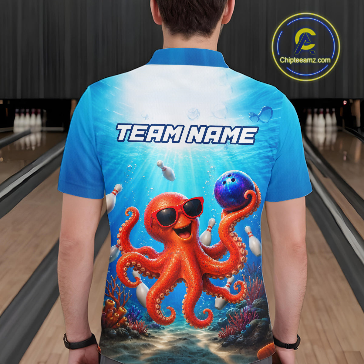 Person wearing a blue bowling shirt with an octopus design and 'Team Name' text on a bowling alley.