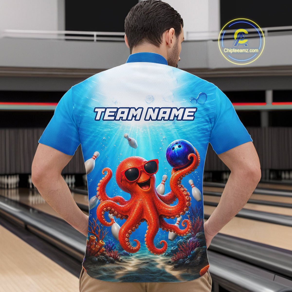 Person wearing a blue shirt with an octopus design and 'TEAM NAME' text in a bowling alley.