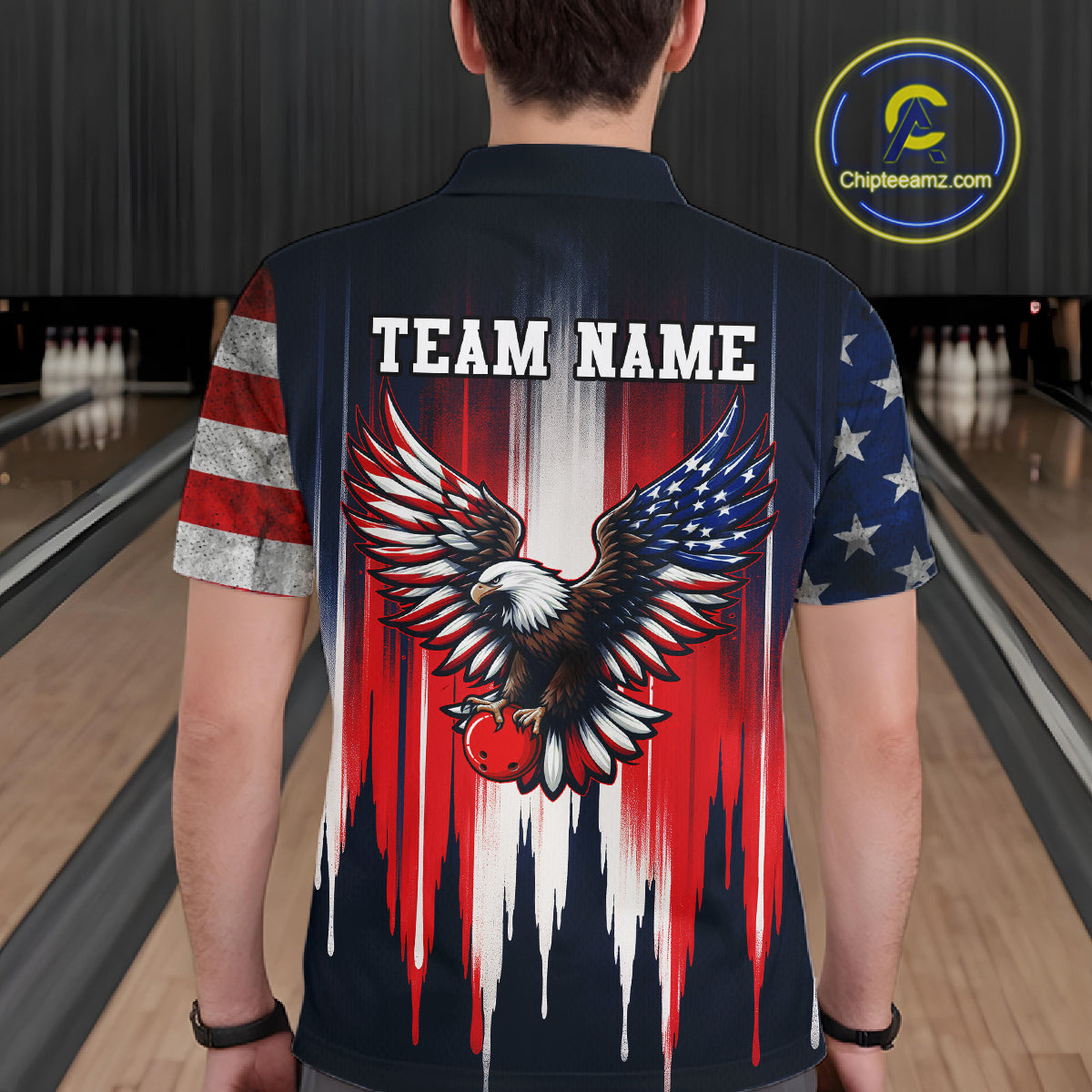 Person wearing a bowling shirt with an eagle design and 'TEAM NAME' text in a bowling alley.