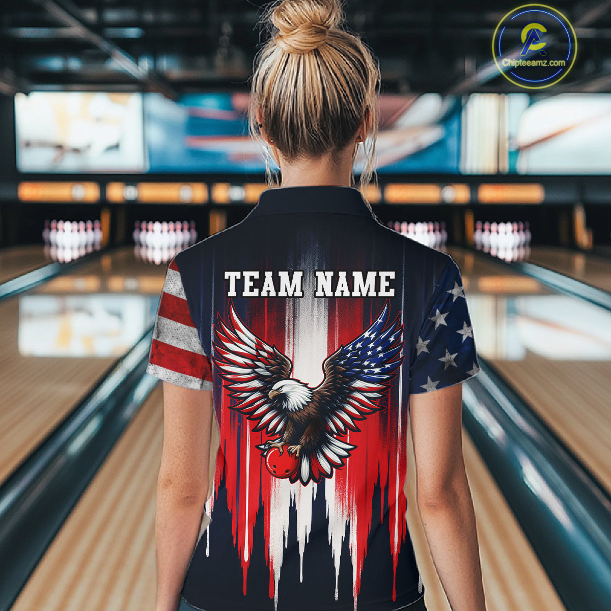 Person wearing a bowling shirt with an eagle design and 'TEAM NAME' text in a bowling alley.