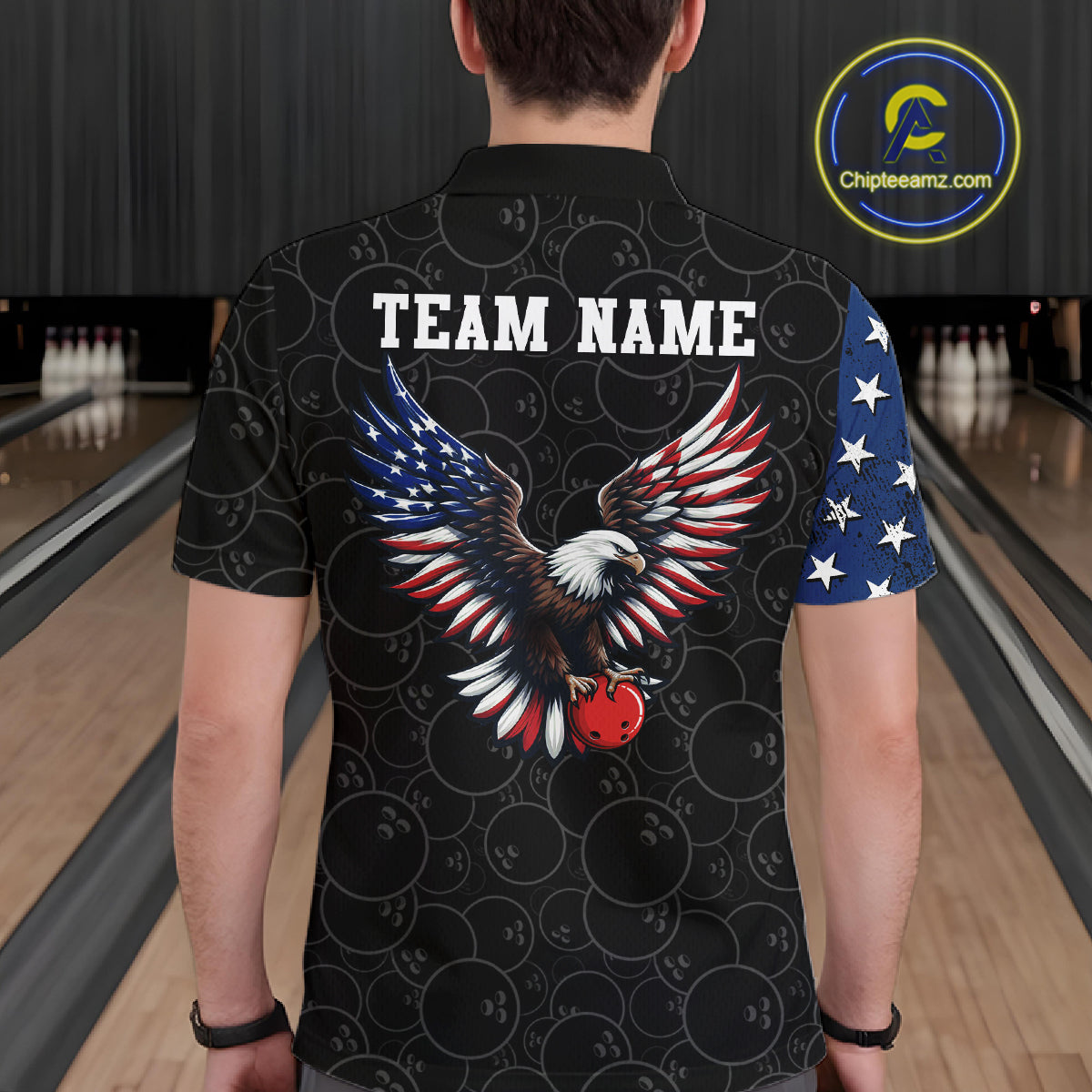 Person wearing a black shirt with an eagle design and 'TEAM NAME' text in a bowling alley.