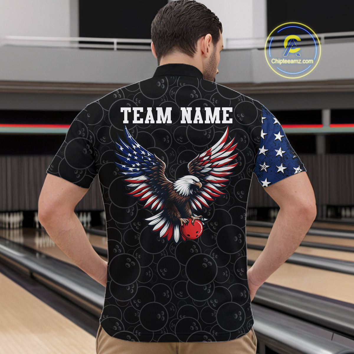 Man wearing a black t-shirt with an eagle design and 'TEAM NAME' text at a bowling alley.
