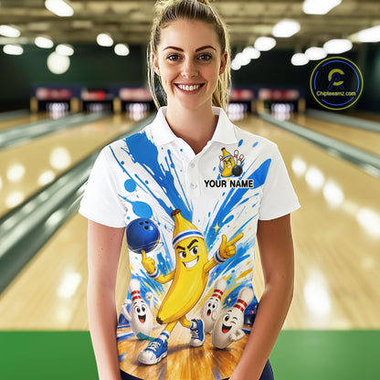 Person wearing a colorful bowling shirt with cartoon characters in a bowling alley.