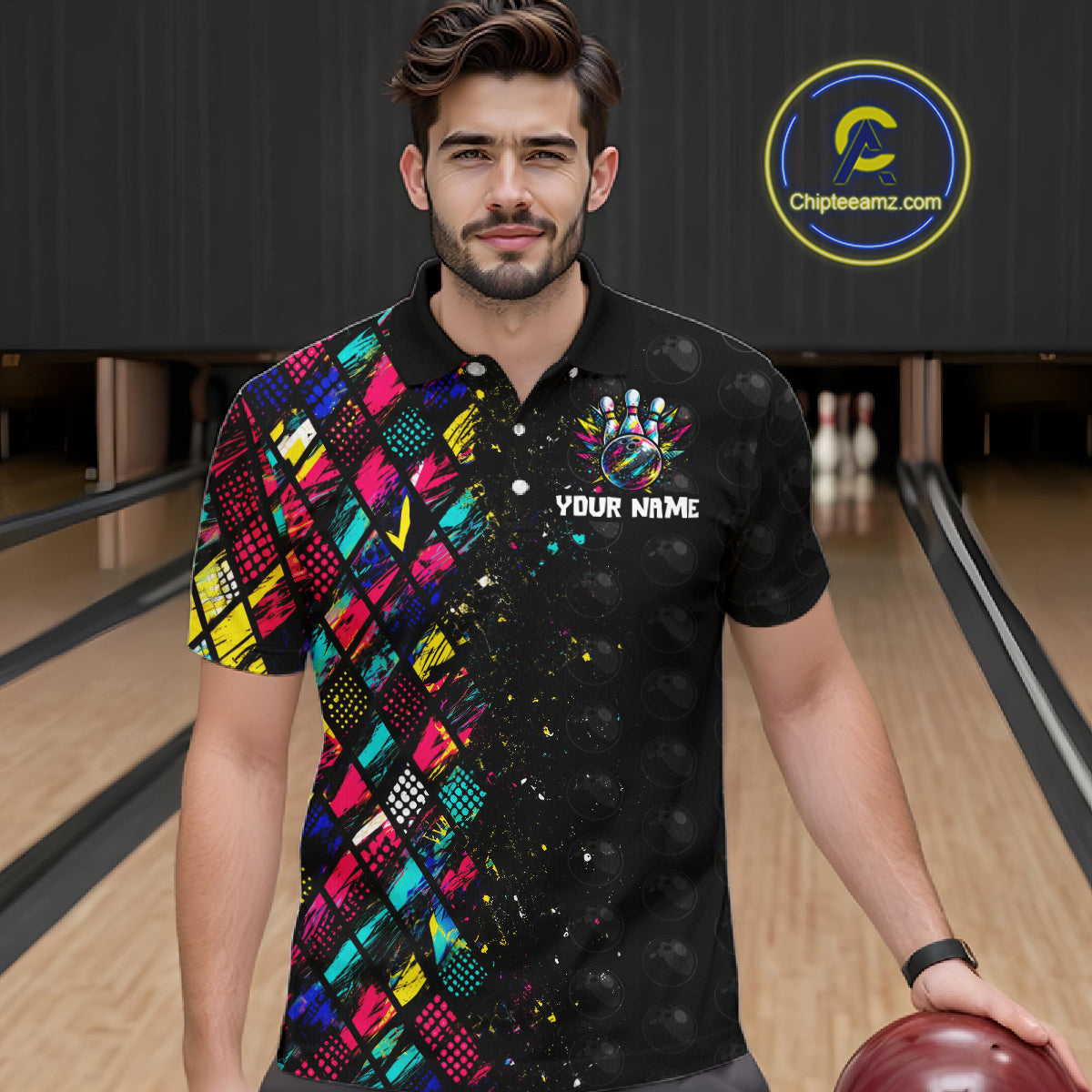 Man wearing a colorful bowling shirt with a logo and text in a bowling alley.