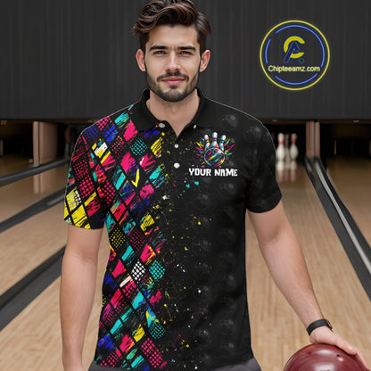 Man wearing a colorful bowling shirt with a logo and text in a bowling alley.