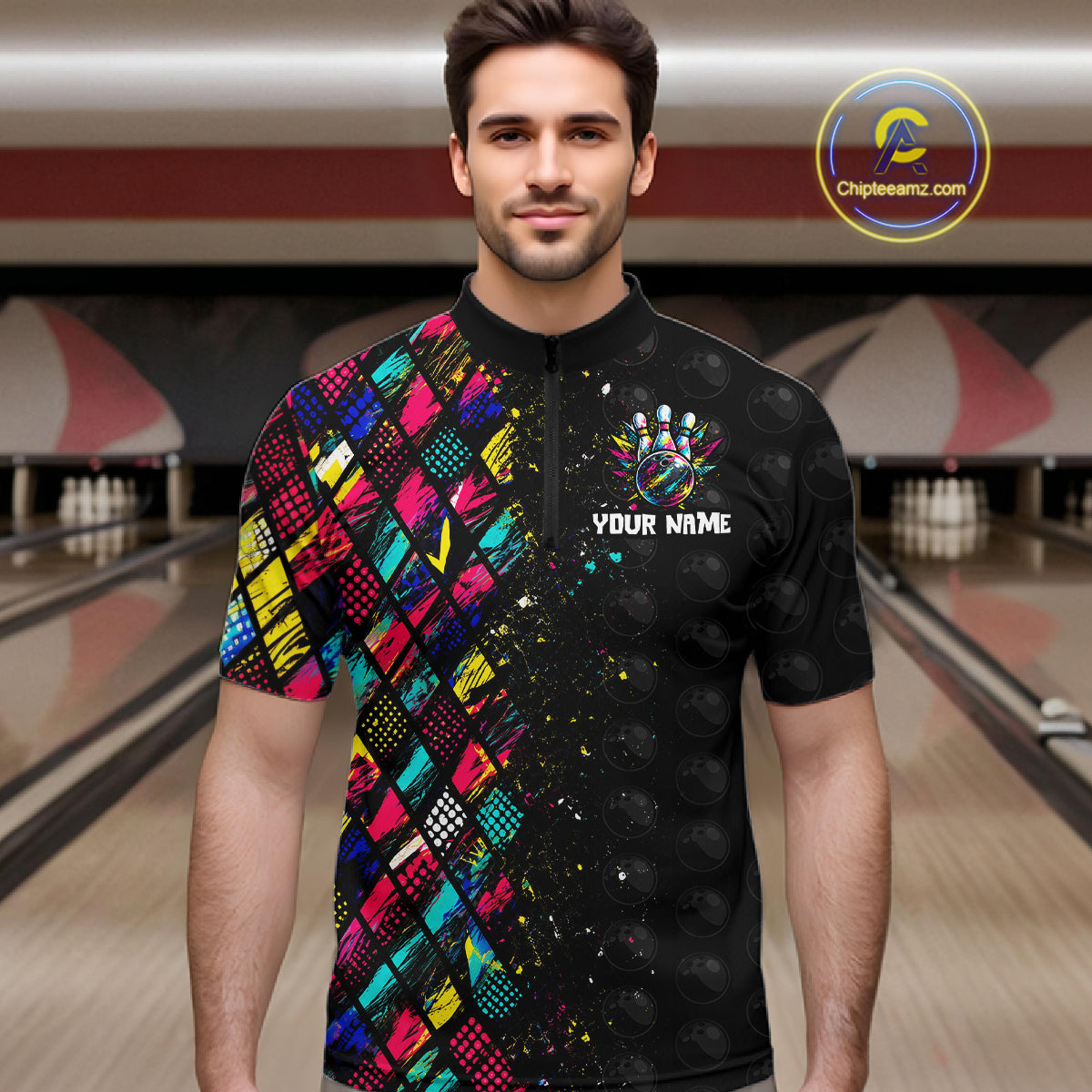 Man wearing a colorful and black bowling shirt with a logo and text in a bowling alley.