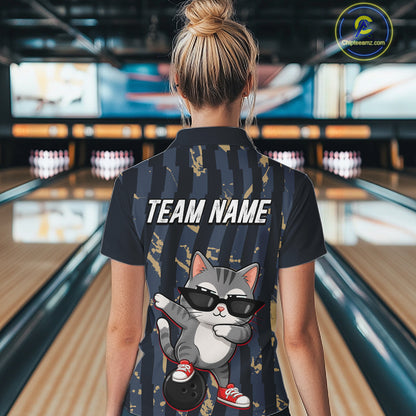 Person wearing a shirt with a cat graphic and 'TEAM NAME' text in a bowling alley.