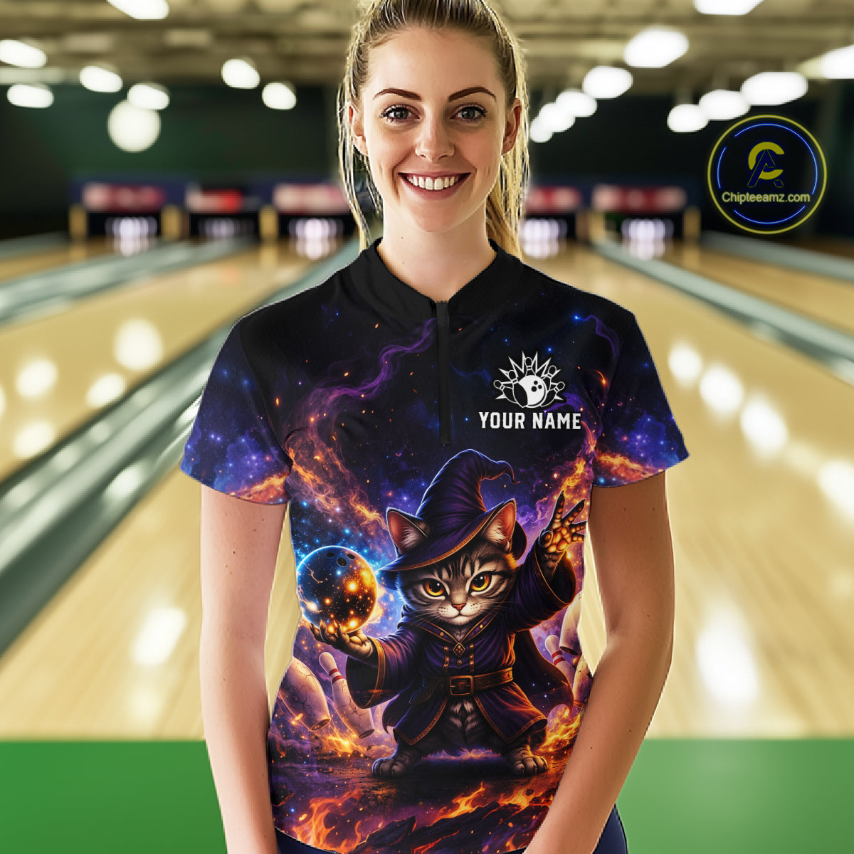 Person wearing a colorful bowling shirt with a cat design in a bowling alley.