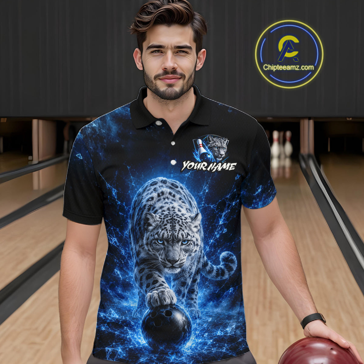 Man wearing a black polo shirt with a blue and white design of a leopard and bowling ball in a bowling alley.