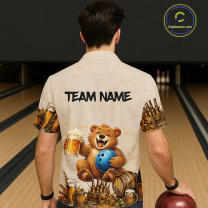 Person wearing a shirt with a bear holding a bowling ball and beer mugs design, standing in a bowling alley.