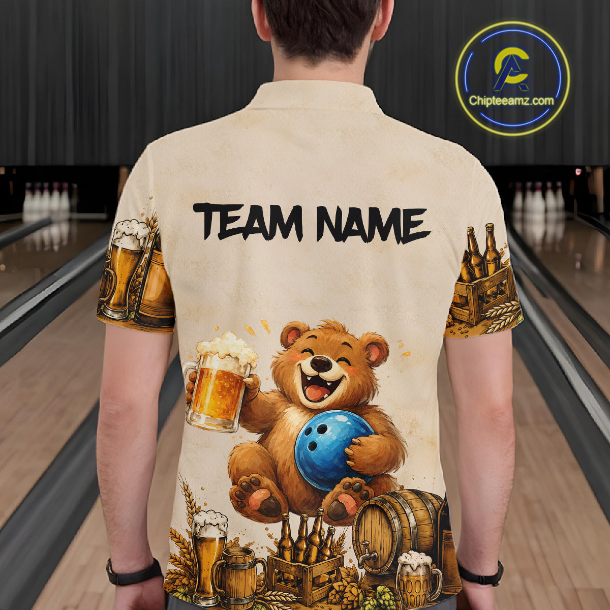 Person wearing a shirt with a bear holding a bowling ball and beer design, standing in a bowling alley.