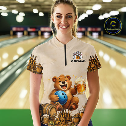 Woman wearing a custom bowling shirt with a bear design in a bowling alley.