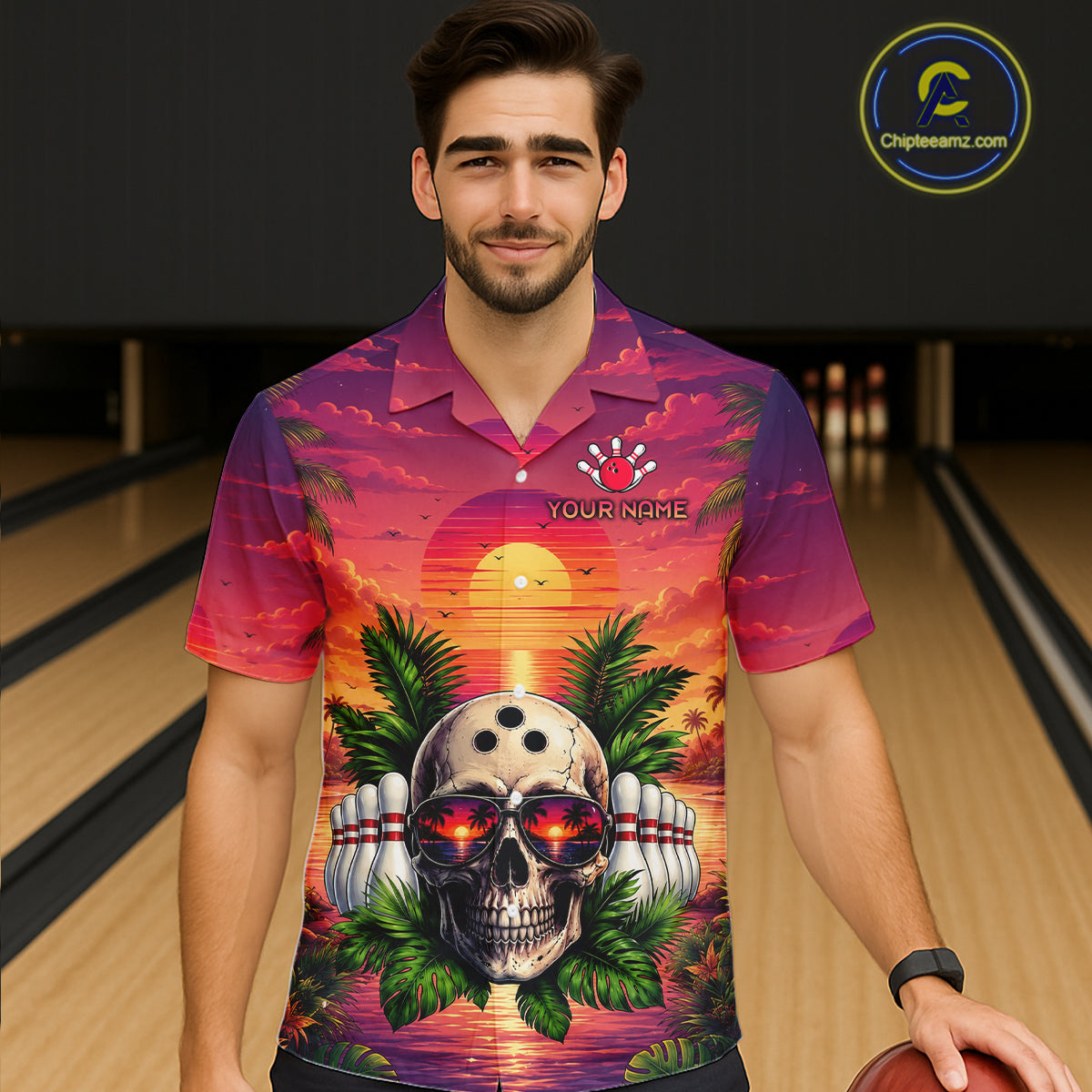 Man wearing a colorful shirt with a skull design in a bowling alley.