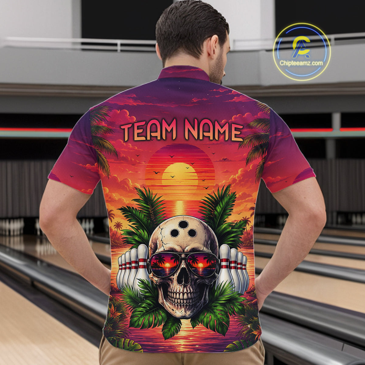 Man wearing a colorful bowling shirt with a skull design in a bowling alley.