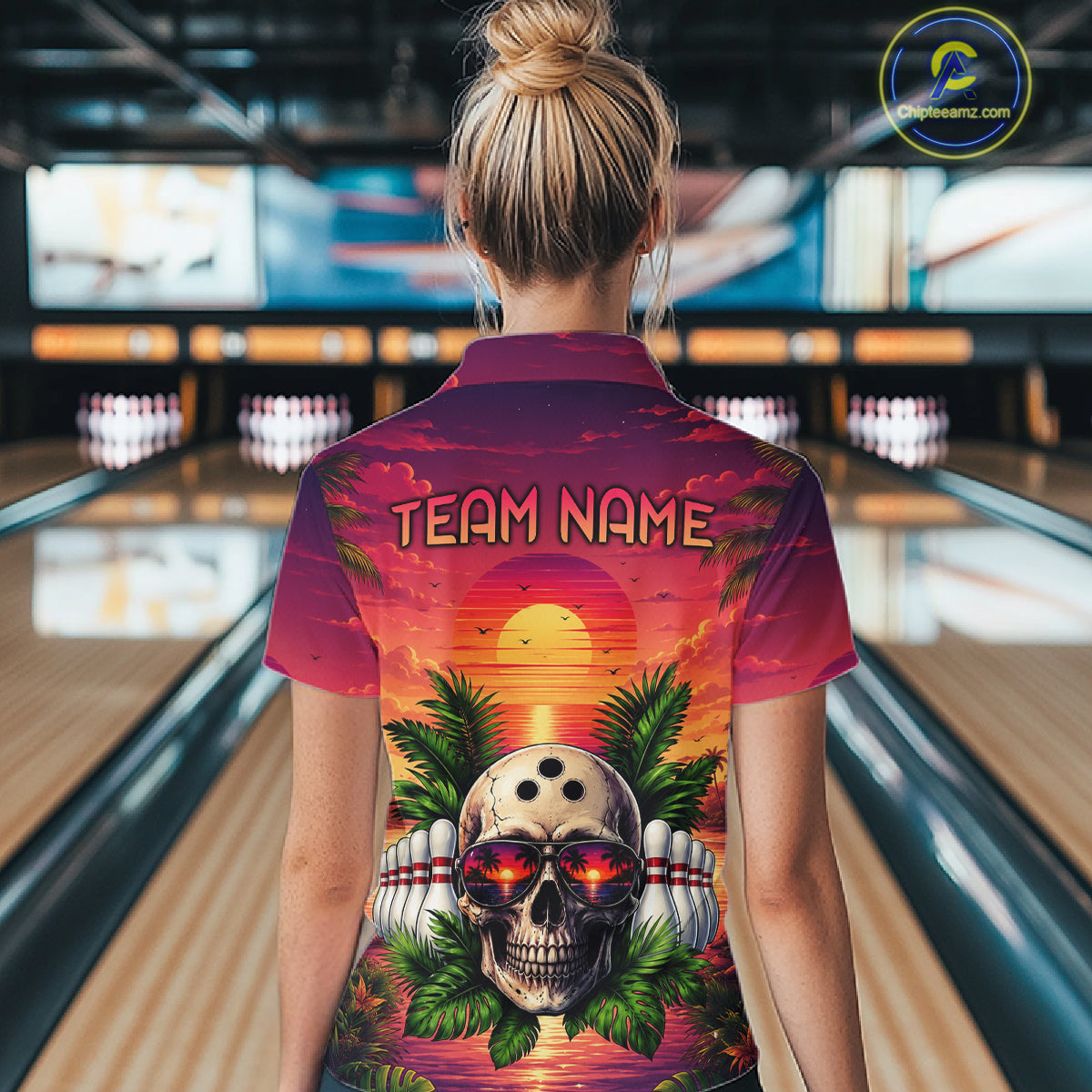 Person wearing a colorful shirt with a skull design and 'TEAM NAME' text in a bowling alley.