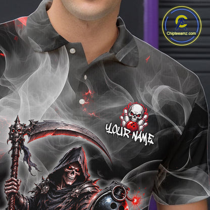 A close-up of a person wearing a dark gray short-sleeve polo shirt with a graphic print. The shirt features a grim reaper holding a scythe, red and white smoke effects, a skull with a red bowling pin, and the text 'YOUR NAME'.