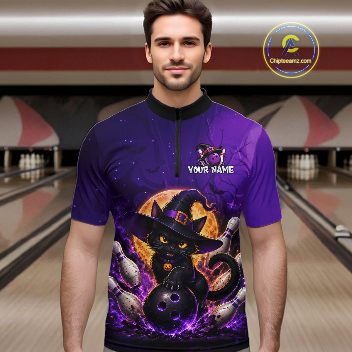 A man wearing a purple short-sleeve quarter-zip bowling shirt with a Halloween graphic of a black cat in a witch hat, bowling pins, and a bowling ball, set against a bowling alley background. 