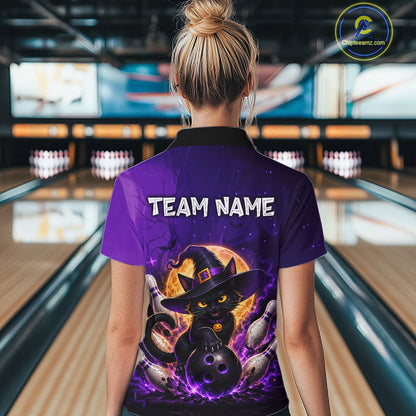 A woman viewed from behind wearing a purple bowling-themed polo shirt with a black cat in a witch hat graphic and the text 'TEAM NAME' on the back, standing in a bowling alley.