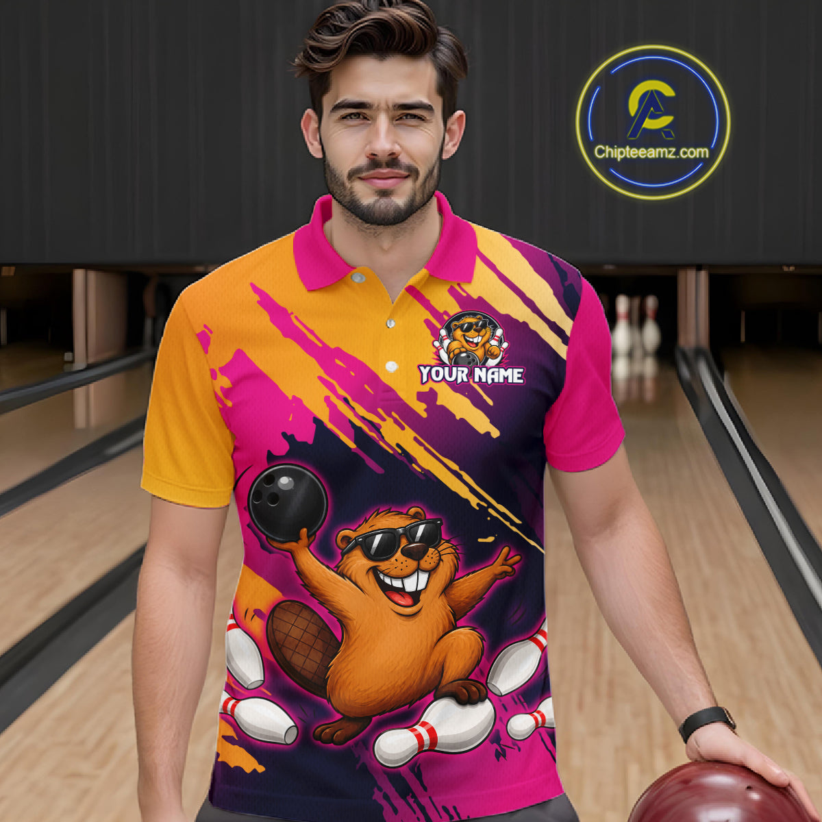 Man wearing a colorful bowling-themed shirt with a logo and text in a bowling alley.