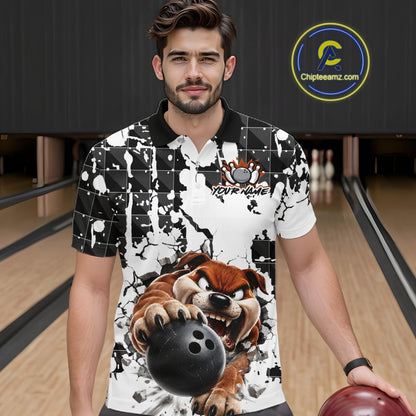 Man wearing a black and white polo shirt with a graphic design of a bear holding a bowling ball in a bowling alley.