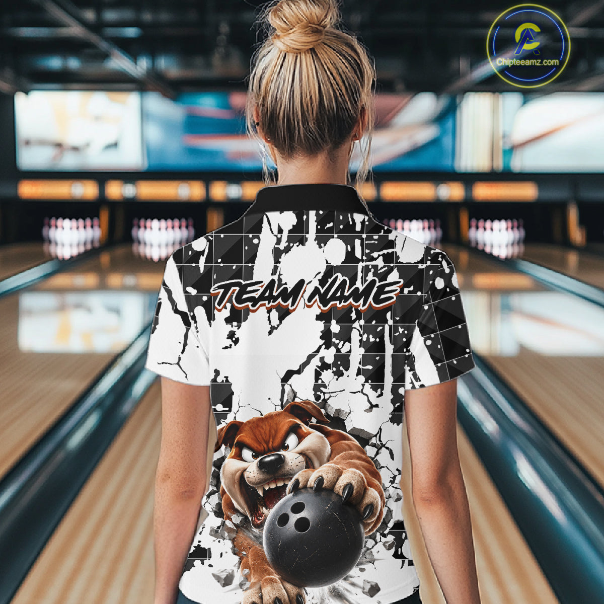 Person wearing a bowling shirt with a dog graphic and 'Team Name' text in a bowling alley.