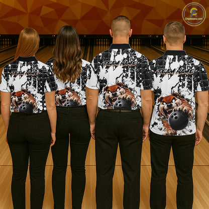 Four people wearing matching bowling shirts with a bulldog and bowling ball design on a bowling alley.