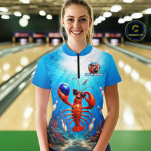 Load image into Gallery viewer, Woman wearing a blue bowling shirt with a lobster design in a bowling alley.