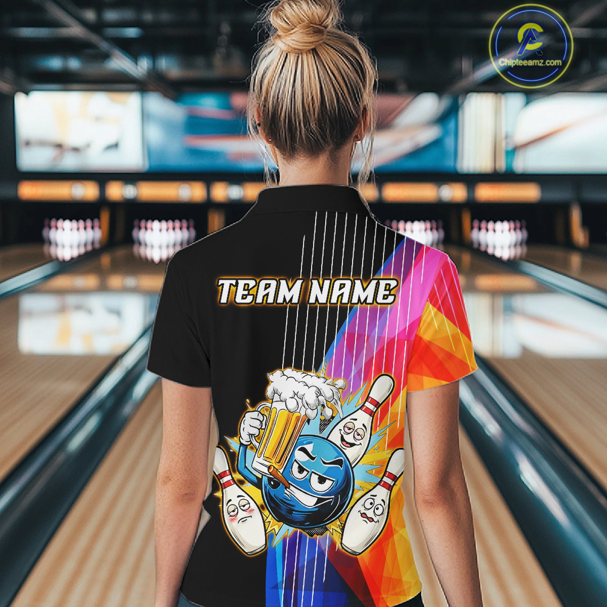 Person wearing a colorful bowling-themed shirt with 'TEAM NAME' text in a bowling alley.