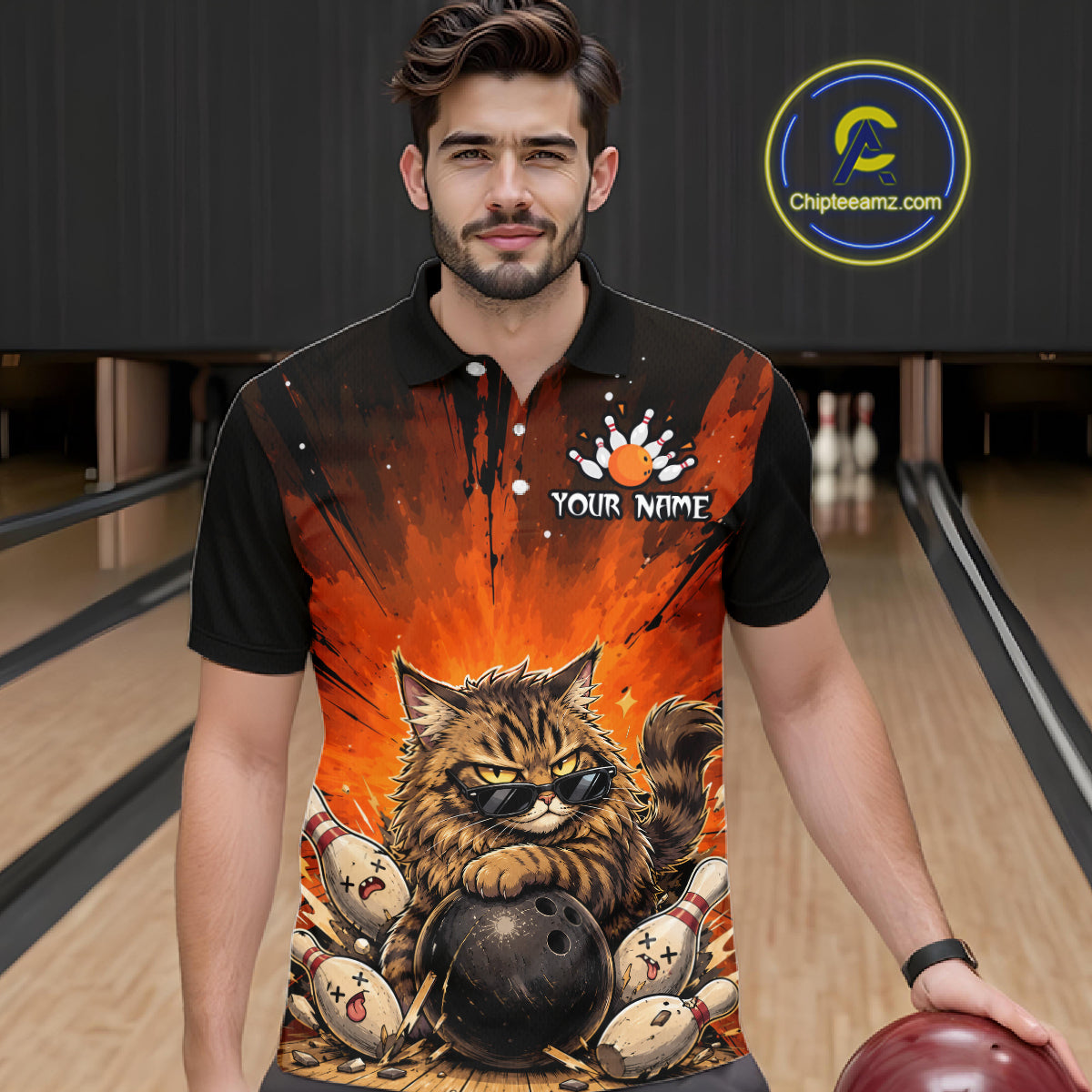 Man wearing a bowling-themed shirt with a cat design in a bowling alley.