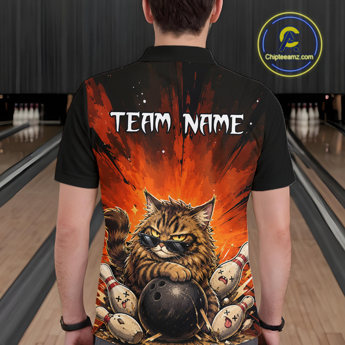 Person wearing a black bowling shirt with a cat design and 'Team Name' text in a bowling alley.