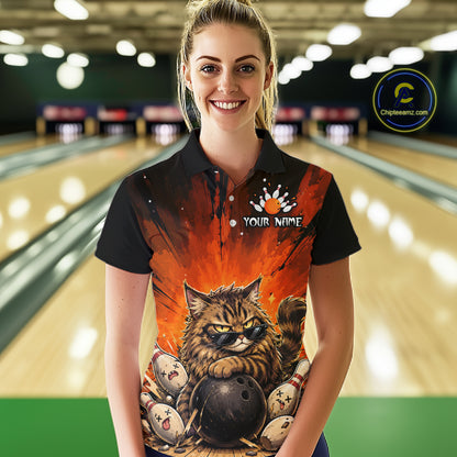 Person wearing a bowling-themed shirt with a cat design in a bowling alley.