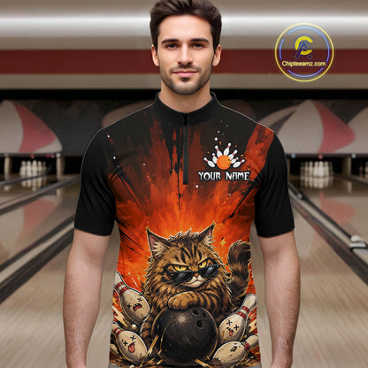 Man wearing a black t-shirt with a colorful design of a cat holding a bowling ball in a bowling alley.