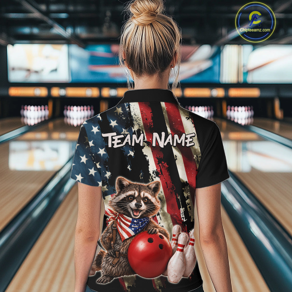 Person wearing a bowling shirt with a raccoon design in a bowling alley