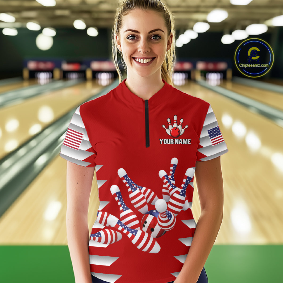 Female model wearing a custom red patriotic bowling quarter-zip shirt front view featuring American flag bowling pins, bowling ball and stars and stripes artwork at the bowling alley
