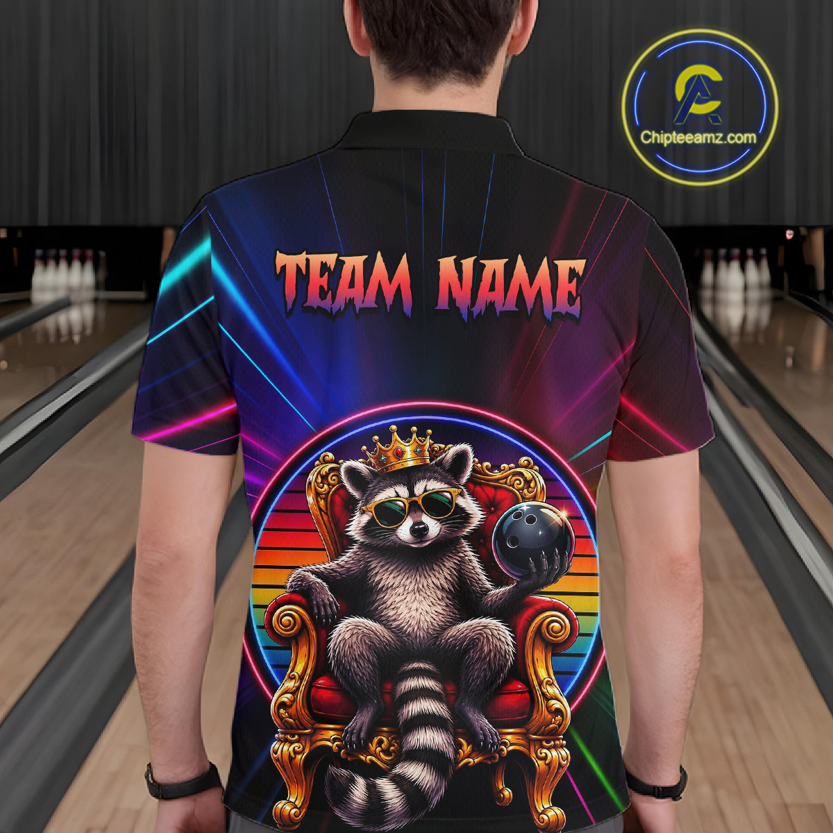 Person wearing a bowling shirt with a raccoon design and 'Team Name' text at a bowling alley.