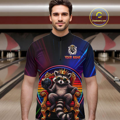 Man wearing a neon shirt with a raccoon design in a bowling alley.