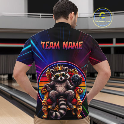 Man wearing a neon shirt with a raccoon graphic and 'TEAM NAME' text in a bowling alley.
